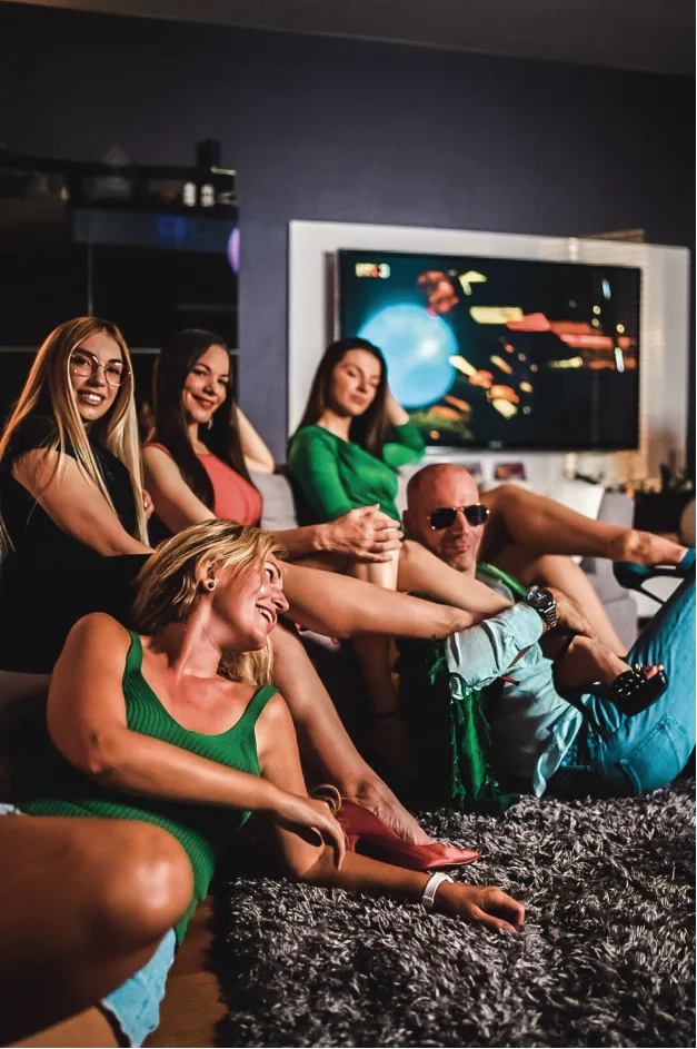 Man with 4 girls in dresses in a living room